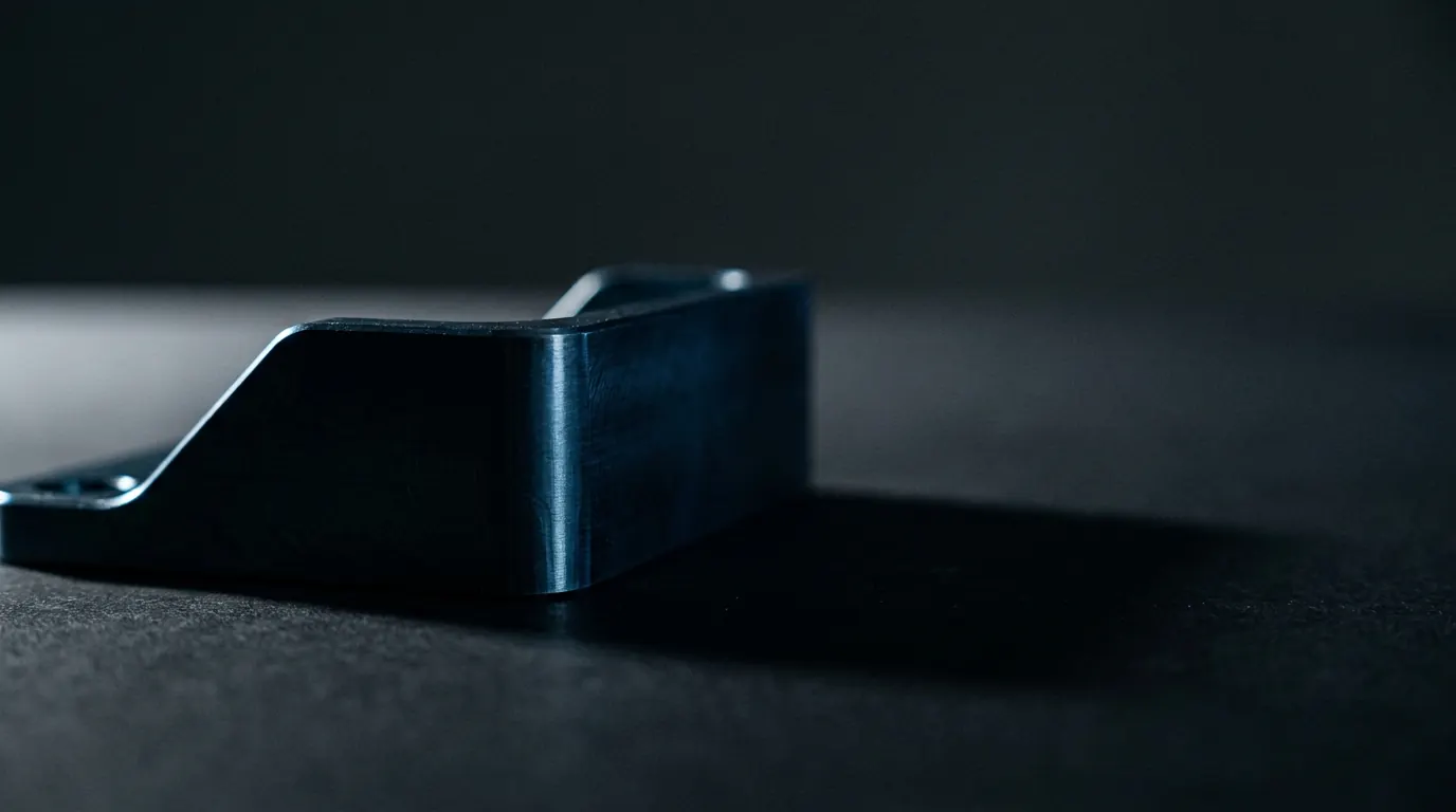 Einzelne gefraeste Metallecke auf mattem Grund mit langem Schatten